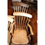 A Windsor lath back elbow chair with panel seat and a smaller, similar, elbow chair