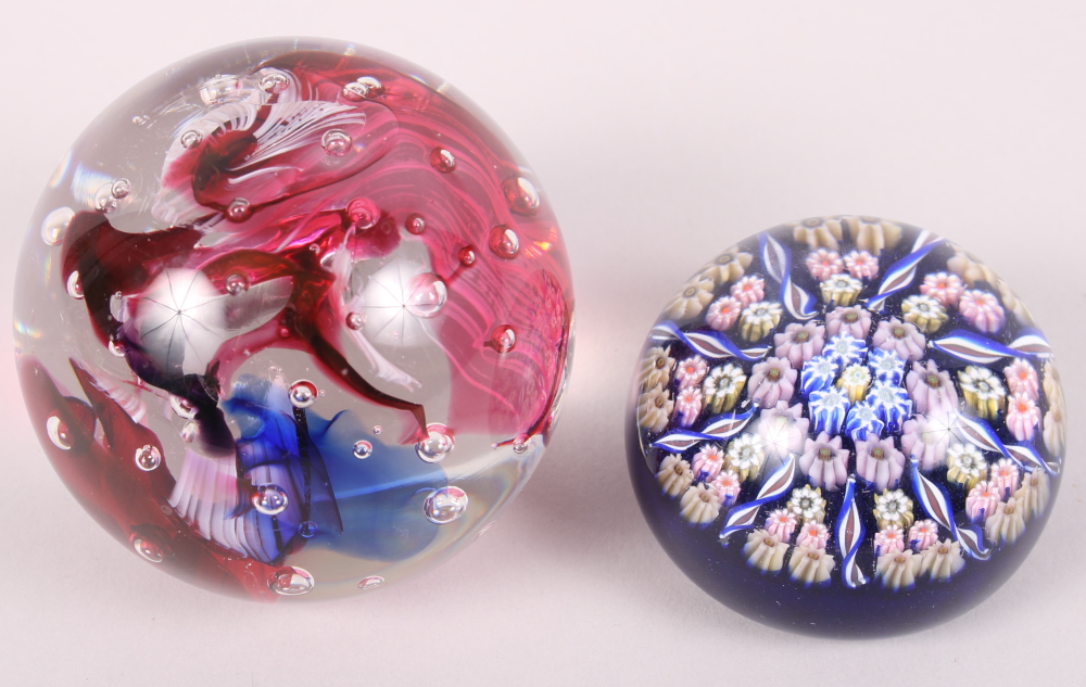 Two glass paperweights, one with "inka" etched to base