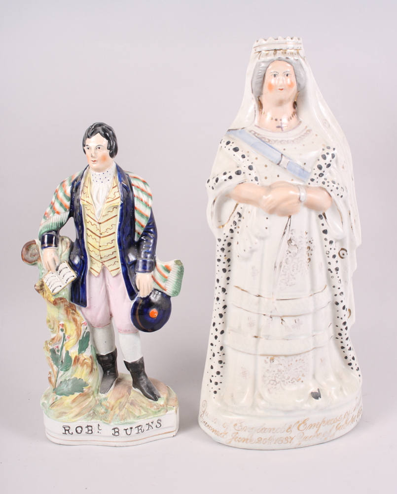 A 19th century Staffordshire figure, Queen Victoria 1897, 17" high, and a similar figure, Robbie