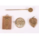 A 9ct gold locket, a heart-shaped locket, a mother-of-pearl locket, decorated the three wise