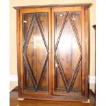 An early 20th century oak display cabinet enclosed lattice glazed doors, 32" wide