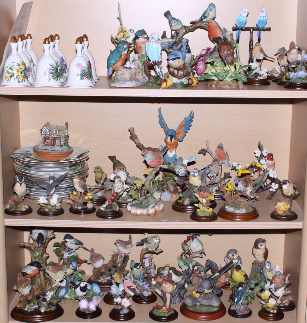 A quantity of porcelain birds, including Country Artist models, Danbury Mint bells, decorated in