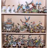 A quantity of porcelain birds, including Country Artist models, Danbury Mint bells, decorated in