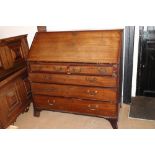 A late Georgian mahogany fall front bureau, interior fitted drawers and pigeonholes, over two
