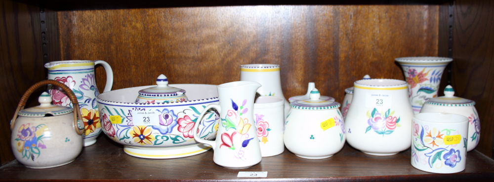 A 1950s Poole bowl with floral decoration, six preserve jars and cover, a jug and a number of