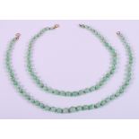 Two graduated jade bead necklaces with yellow metal clasps, longest 18" approx