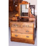 An early 20th century mahogany dressing chest with swing mirror flanked twin drawers over two