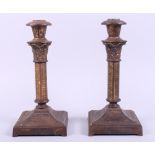 A pair of cast iron Corinthian column candlesticks