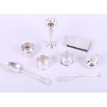 Two silver napkin rings, a silver fork, a silver spoon, a silver match box sleeve, a miniature
