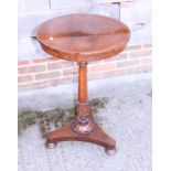 A rosewood circular top stand, on octagonal column with three bun feet, 17 1/2" dia