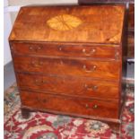 A George III mahogany and yew bureau with fan patterae decoration, four graduated drawers, on