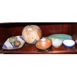 An assortment of studio pottery including a green glazed vase, bowls, etc