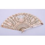 A late 19th century hand-painted bone, horn, mother-of-pearl and silk fan, with sequin and lace