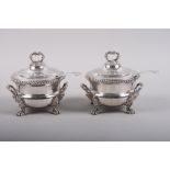 A pair of late Georgian Sheffield plate two-handled sauce tureens and covers, on acanthus and lion