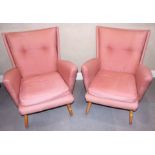 A pair of late 1940s deep seat wing armchairs with linen covers, on splay supports