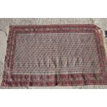 A sumac type flat weave rug with all-over bird and flower design on a white ground and multi-