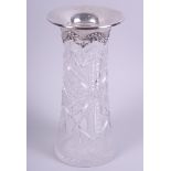 A cut glass vase of slender tapered form with silver decorated bows and floral swags, 10" high