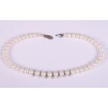 A graduated pearl necklace, hung seven white metal drops, set diamond accents, 16 1/2" long
