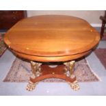 An American Horner Federal design mahogany and carved giltwood extending dining table with two extra