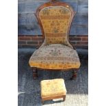 A Victorian oak nursing chair, upholstered in a floral fabric, and a matching stool
