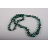 A malachite graduated bead necklace, 22" long overall