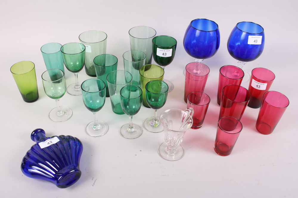 A selection of cranberry and green drinking glasses, two Bristol blue brandy balloons, a similar