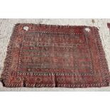 A Caucasian tribal rug with banded centre and hooked guls to the borders in shades of rust, red,