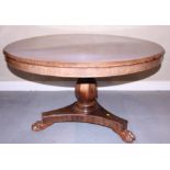 An early Victorian rosewood circular dining table, on an octagonal column and three carved paw