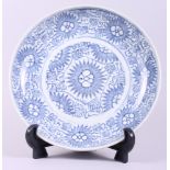 A Chinese provincial style blue and white porcelain dish with unglazed base, 10" dia