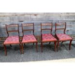 Four Regency design grained as walnut dining chairs with brass inlaid decoration
