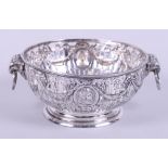 A silver pedestal basket with pierced and embossed decoration and rams head handles, 7.4oz troy