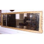 A 19th century three-plate rectangular mirror with bevelled glass and carved gilt frame, 19" x 55