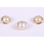 A 9ct gold ring set pearl, ring size L, and a similar pair of yellow metal mounted pearl earrings,