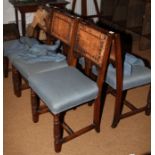 A set of six oak dining chairs of 17th century design with padded seats and leather backs