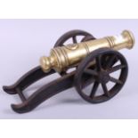 A 19th century bronze model of a cannon, on a cast carriage, 14" long