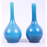 A Chinese turquoise sprinkler bottle with unglazed base and another similar with glazed base