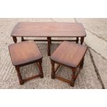 An Ercol elm low coffee table, 44" wide, with two smaller nesting tables, 18" wide, an Ercol elm