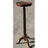 A polished as mahogany jardiniere stand with spiral turned column, on tripod splay supports, 11"