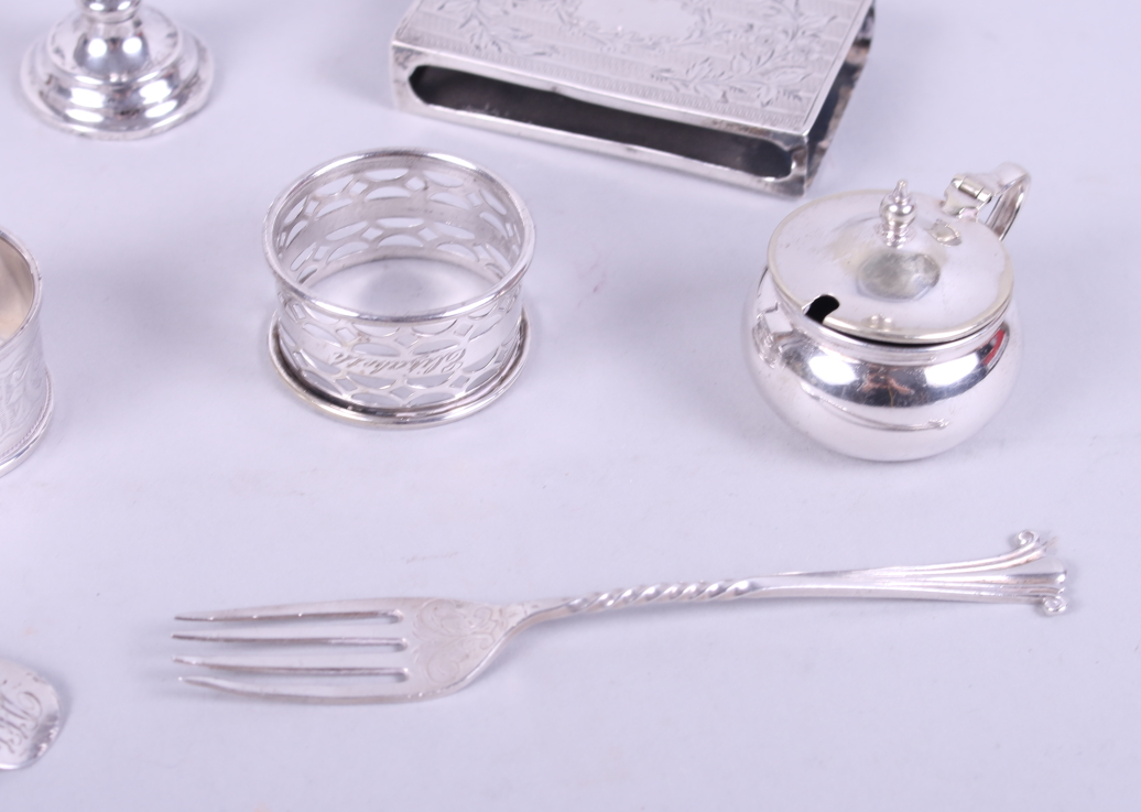 Two silver napkin rings, a silver fork, a silver spoon, a silver match box sleeve, a miniature - Image 3 of 4