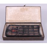 A Chinese ink block, decorated, dragons and archaic script, boxed