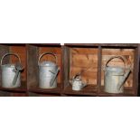 Four galvanised watering cans, various sizes