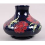 A Moorcroft "Anemone" pattern squat vase, designed by Sally Tuffin, 7 1/2" high