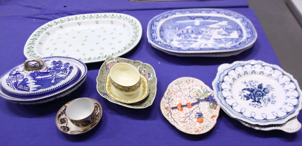 A Willow pattern platter, a similar tureen, three other platters, Wedgwood creamware and other