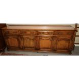 An early 20th century oak sideboard with four drawers over four cupboards, on square supports, 93