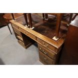 A walnut double pedestal desk with red American cloth lined top, fitted nine drawers, top 54" x 26"