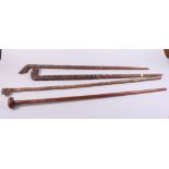 Two Dyak carved walking sticks, a palmwood walking stick and one other hardwood stick