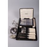 A silver plated wine funnel, two knife rests, a snuff box, a cased set of fish knives and forks