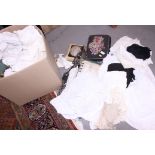 A quantity of linen and mixed textiles, including christening gowns, cushions, lace and other items