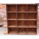 A stripped pine open bookcase enclosed twelve pigeonholes, 64" x 74"
