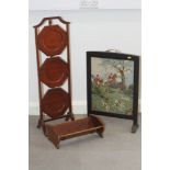 A mahogany three-tier cake stand, a book trough and a needlepoint hunting scene firescreen